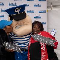 louie takes a picture with women at photo booth